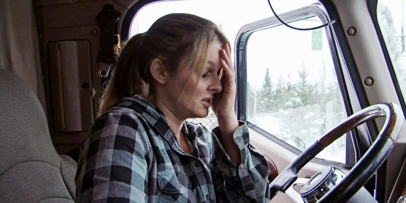 Lisa Kelly sits in a vehicle with her hand on her forehead, frustrated, in Ice Road Truckers.