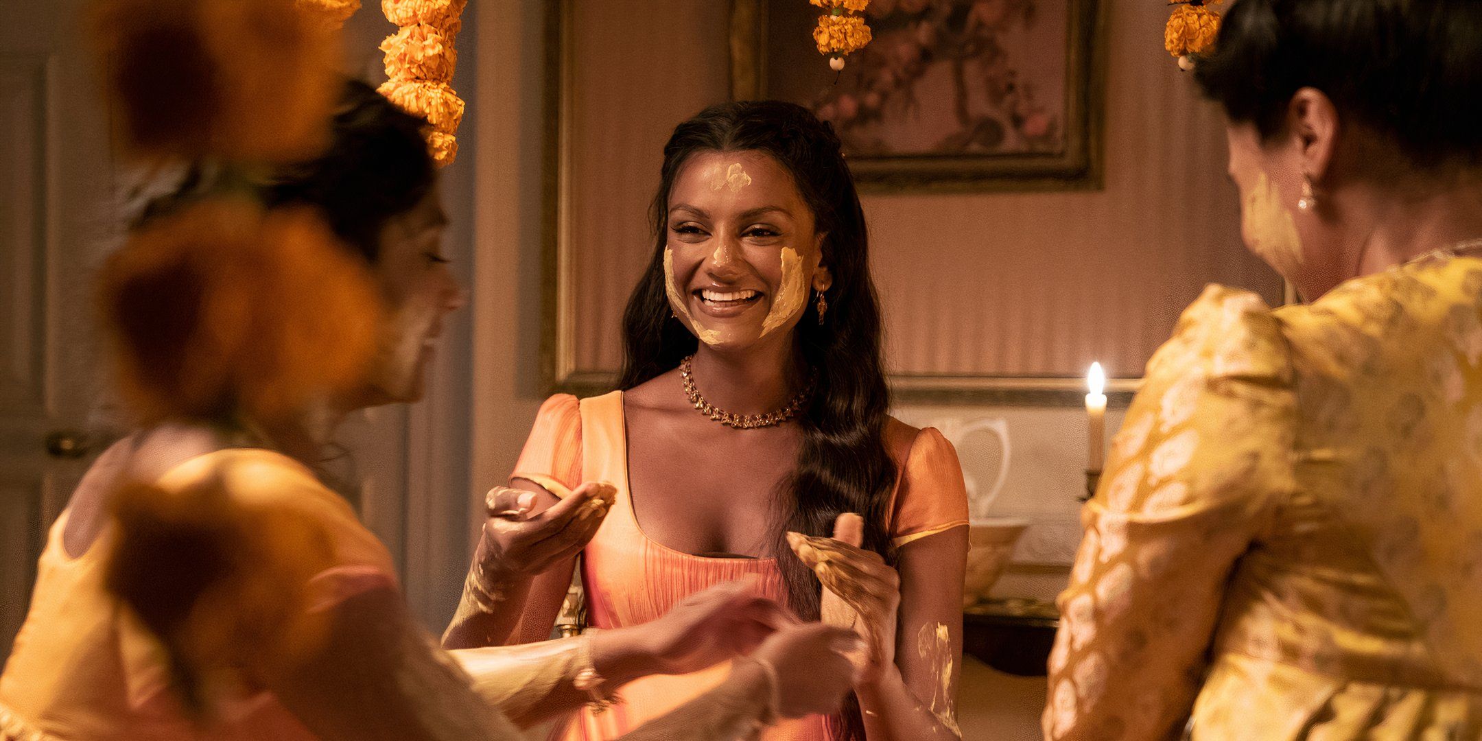 Simone Ashley as Kate Sharma participating in haldi ceremony with family in Bridgerton Season 2.