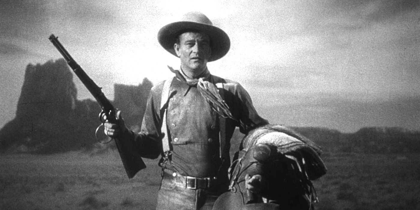 John Wayne as Ringo Kid stands in an open field in Stagecoach