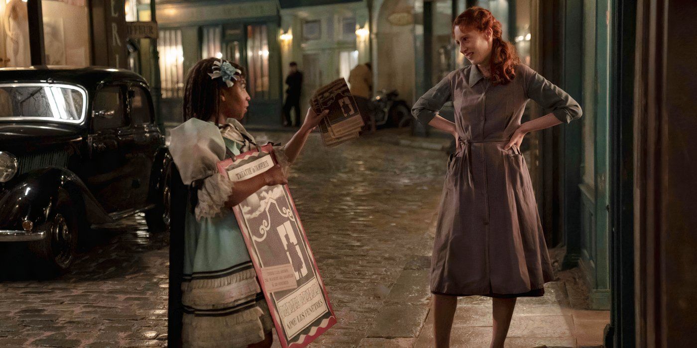 Claudia (Delainey Hayles) in her child costume offers Madeleine (Roxanne Duran) a program in Interview with a Vampire in front of Madeleine's clothing store