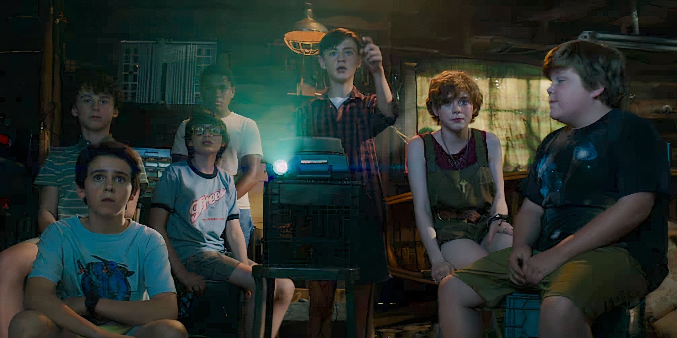 Stanley (Wyatt Oleff), Eddie (Jack Dylan Grazer), Mike (Chosen Jacobs), Richie (Finn Wolfhard), Bill (Jaeden Martell), Beverly (Sophia Lillis), and Ben (Jeremy Ray Taylor) watch a projector in 'It' (2017)