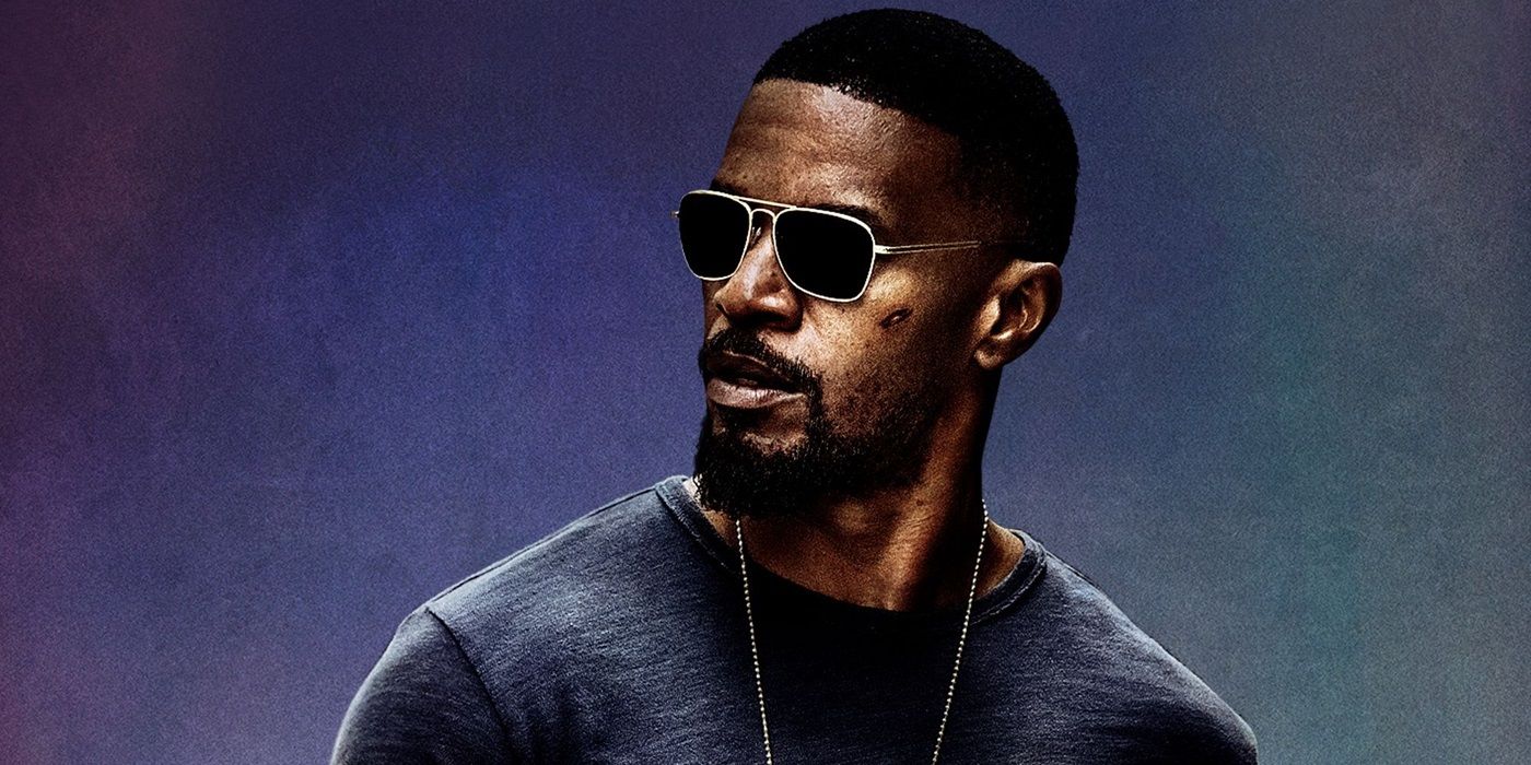 Jamie Foxx as Vincent Downs looking back on a cropped poster of 2017's Sleepless