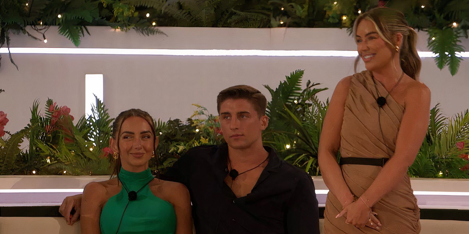 Jess smiling mischievously while sitting next to Sean in Love Island UK Season 11