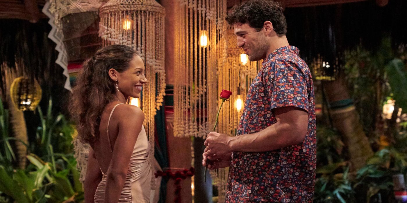 A man handing a woman a rose as she smiles in Bachelor in Paradise