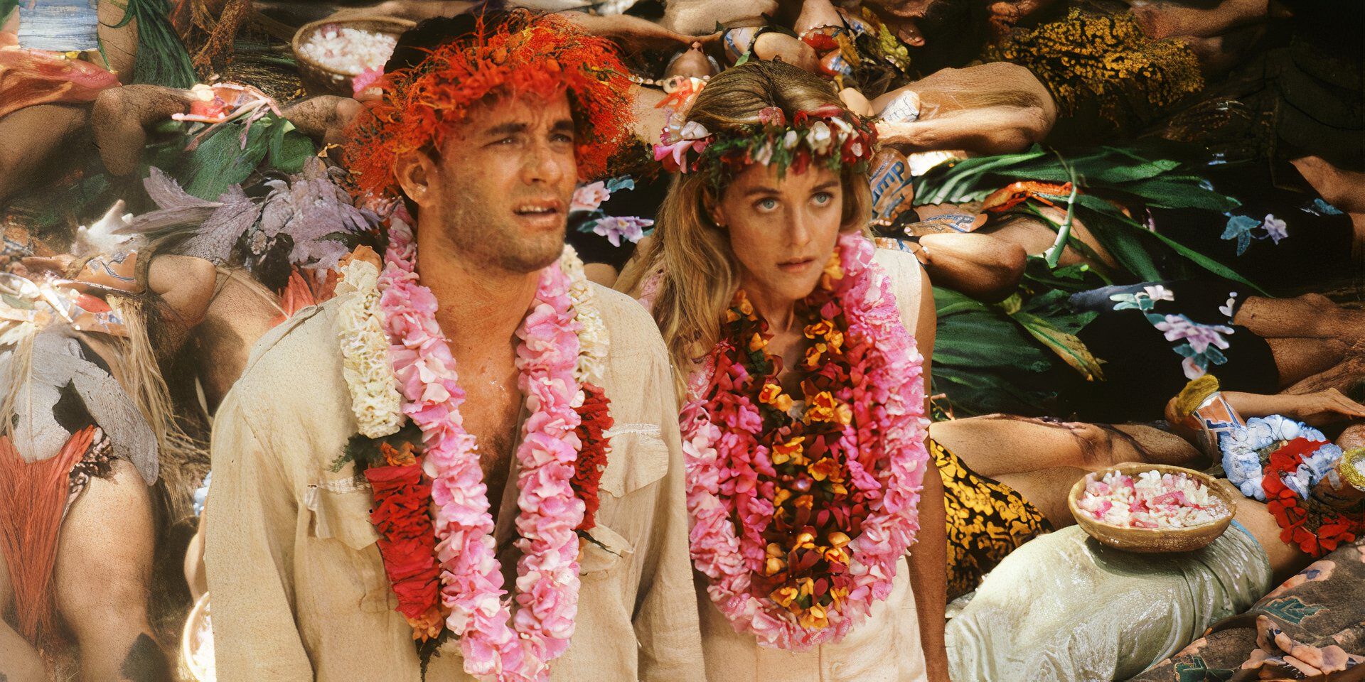 Joe and Patricia attending an island ceremony and covered in flower lei necklaces in 'Joe Versus the Volcano' (1990)