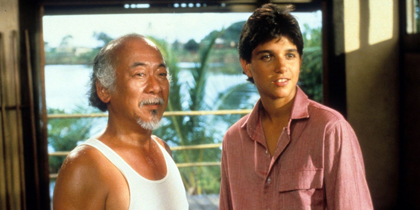 Pat Morita as Mr. Miyagi and Ralph Macchio as Daniel LaRusso standing side by side in Karate Kid II