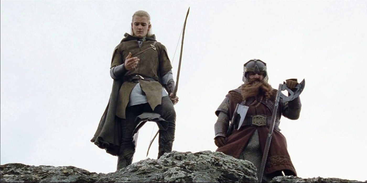 Legolas and Gimli stand on the edge of a cliff, looking down as they believe Aragorn has fallen in 'The Lord of the Rings: The Two Towers' (2002).