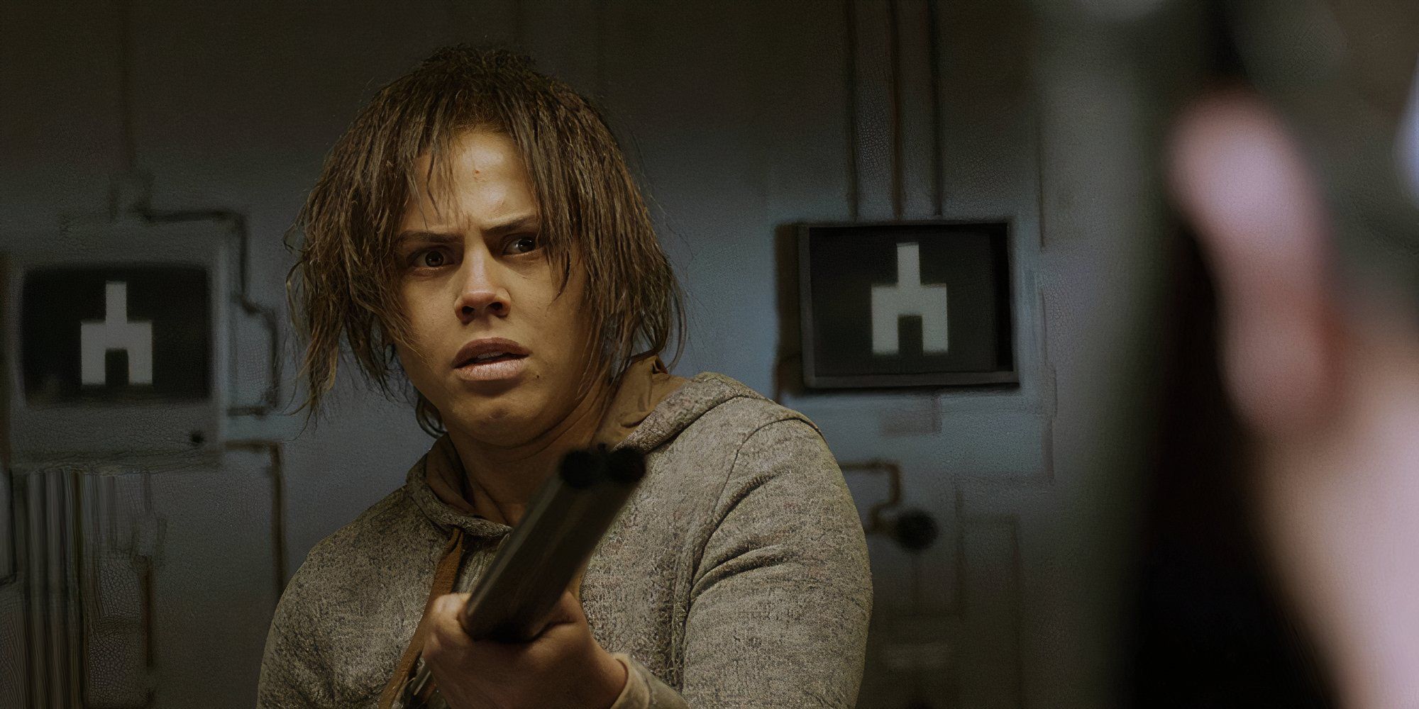 Lenora Crichlow as Victoria in Black Mirror White Bear holding a gun.