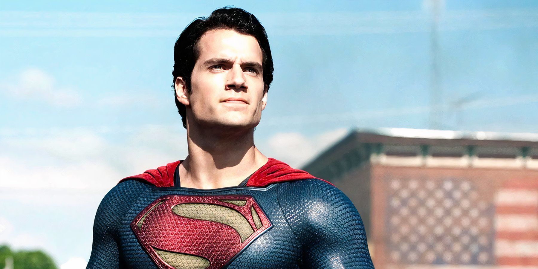 Superman stands heroically in the streets of Smallville Kansas in Man of Steel.