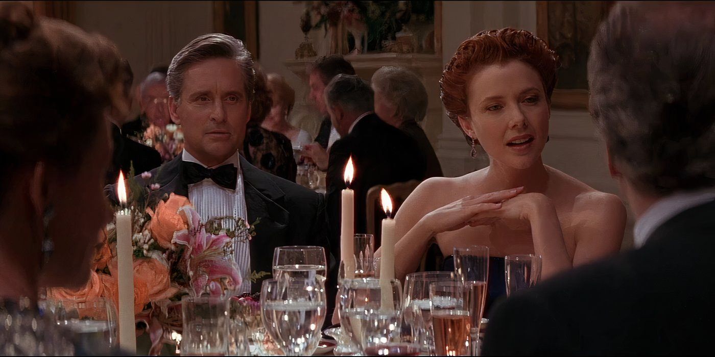 Michael Douglas and Annette Bening in black tie attire seated as a dinner table