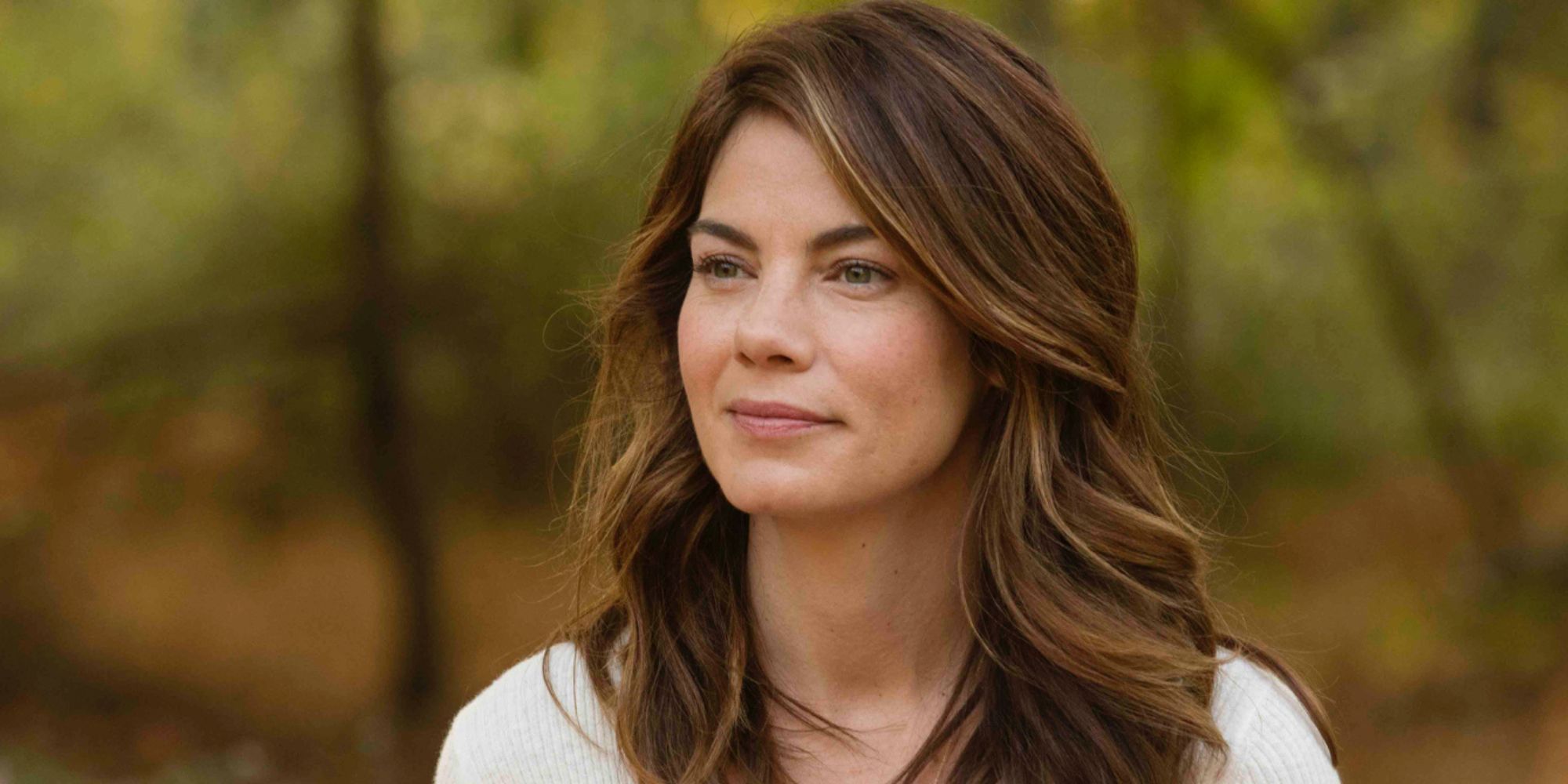 Michelle Monaghan as Sarah Lane standing in a forest in The Path