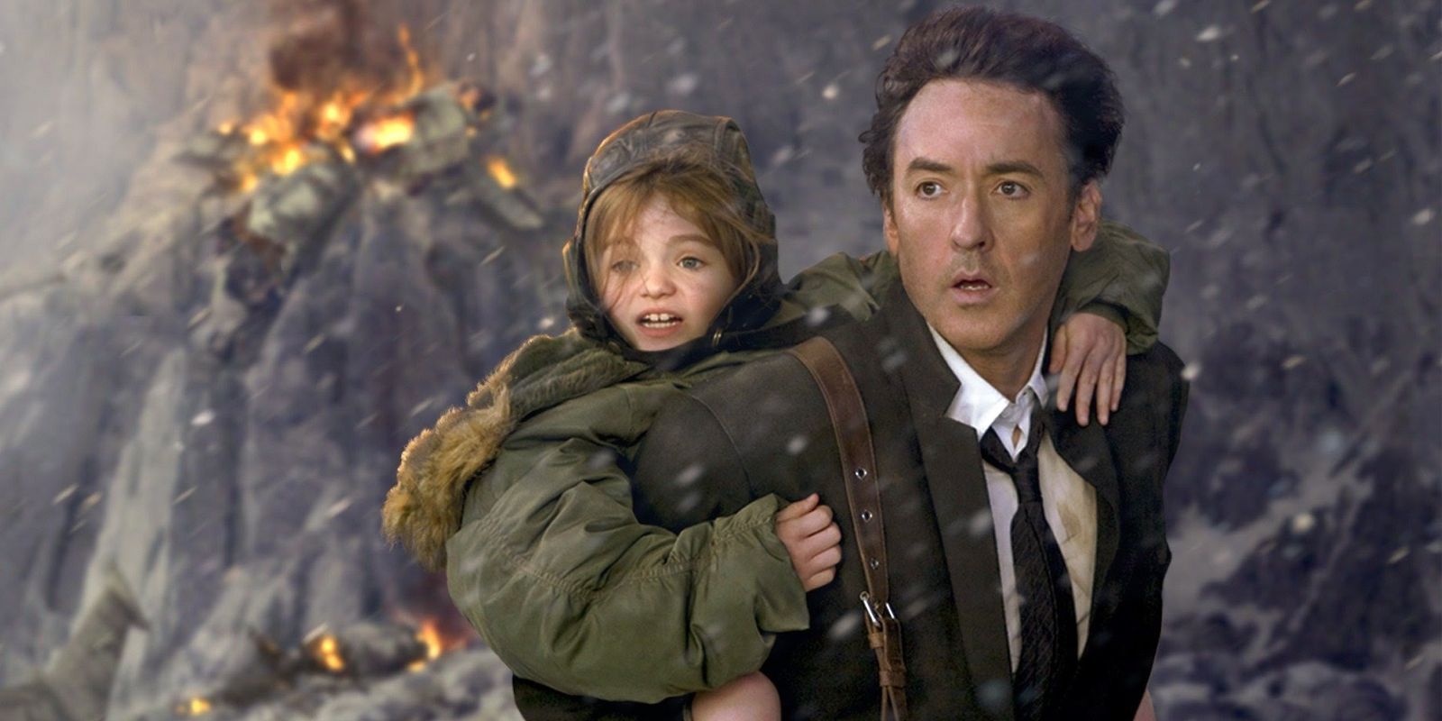 A man and his young daughter look on fearfully as as a fire and other dangers rage around them