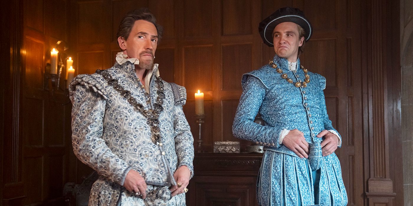 Rob Brydon as Dudley standing next to Henry Ashton as Stan in formal dress in My Lady Jane