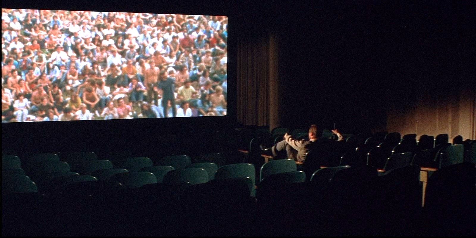 Charlton Heston as Robert Neville in an empty movie theater in The Omega Man