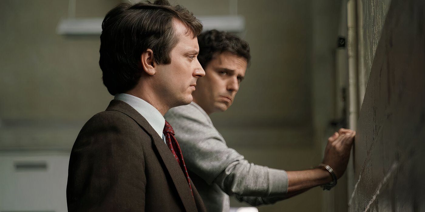 Elijah Wood as Bill (front) looks through a window as Luke Kirby as Ted Bundy (back) looks at BIll