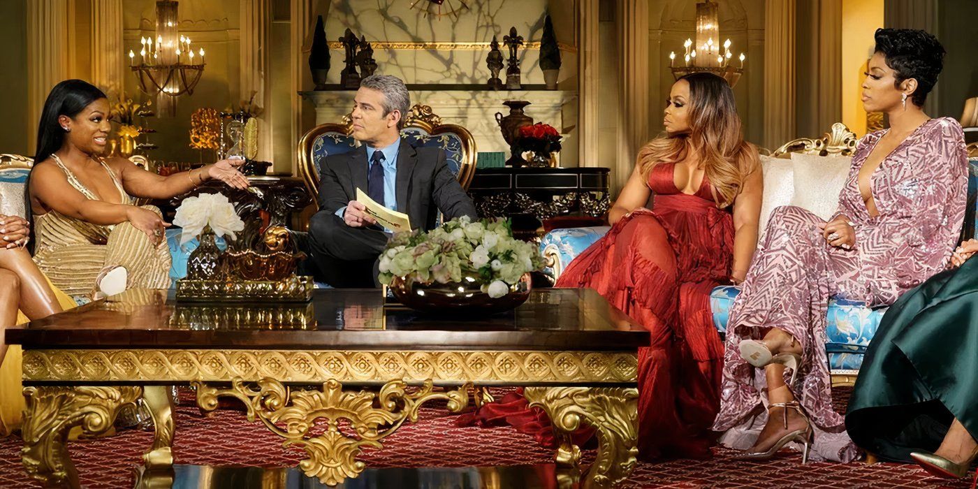 Kandi Burruss and Phaedra Parks flanking Andy Cohen at RHOA Reunion.