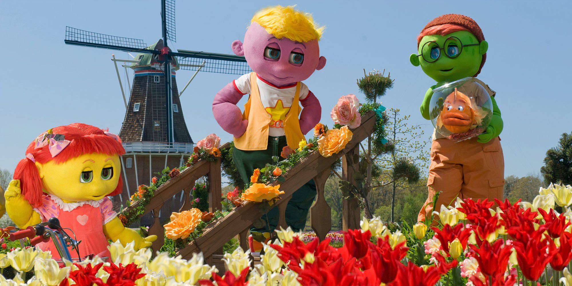 Toofie, Zoozie, Goobie, and Ruffy in a field of flowers in 'The Oogieloves in the Big Balloon Adventure'