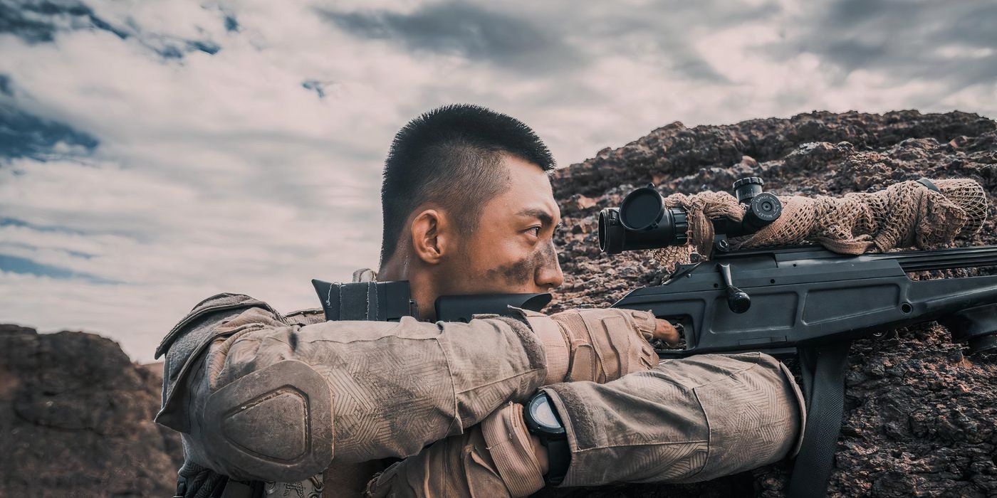 A Chinese soldier mans a machine gun emplacement in a sandy trench