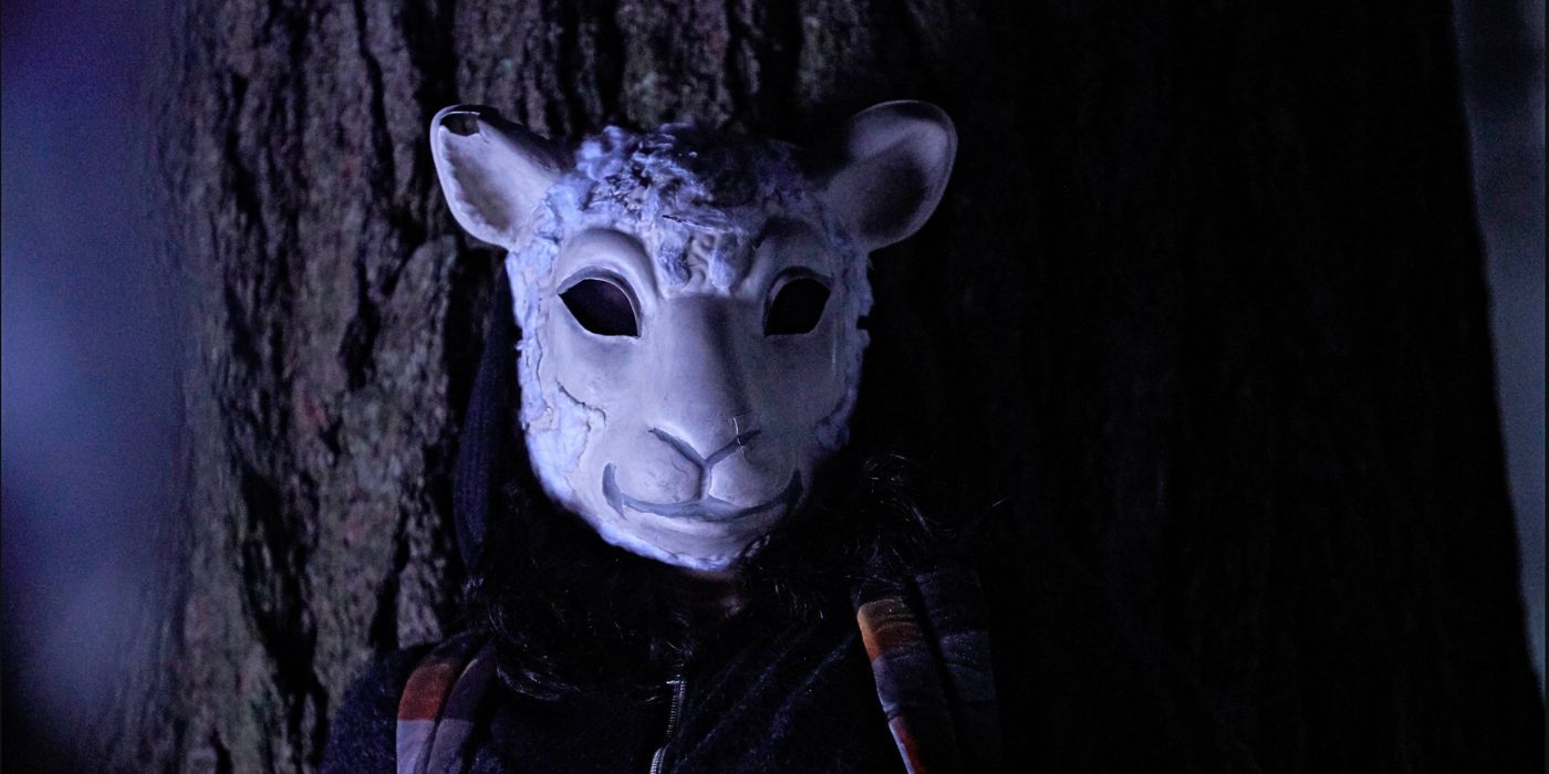 Tatiana Maslany wears a sheep mask as clone MK standing outside in the dark from the episode Collapse of Nature in Orphan Black