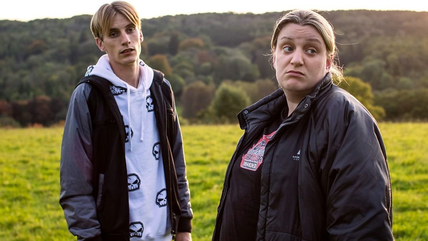 Two people look at the countryside. 