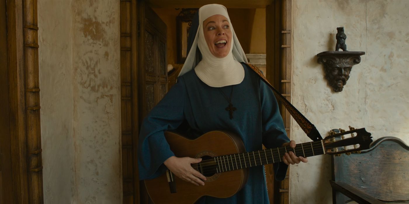 Olivia Colman dressed as a nun playing a guitar as the Reverend Mother in Paddington in Peru.