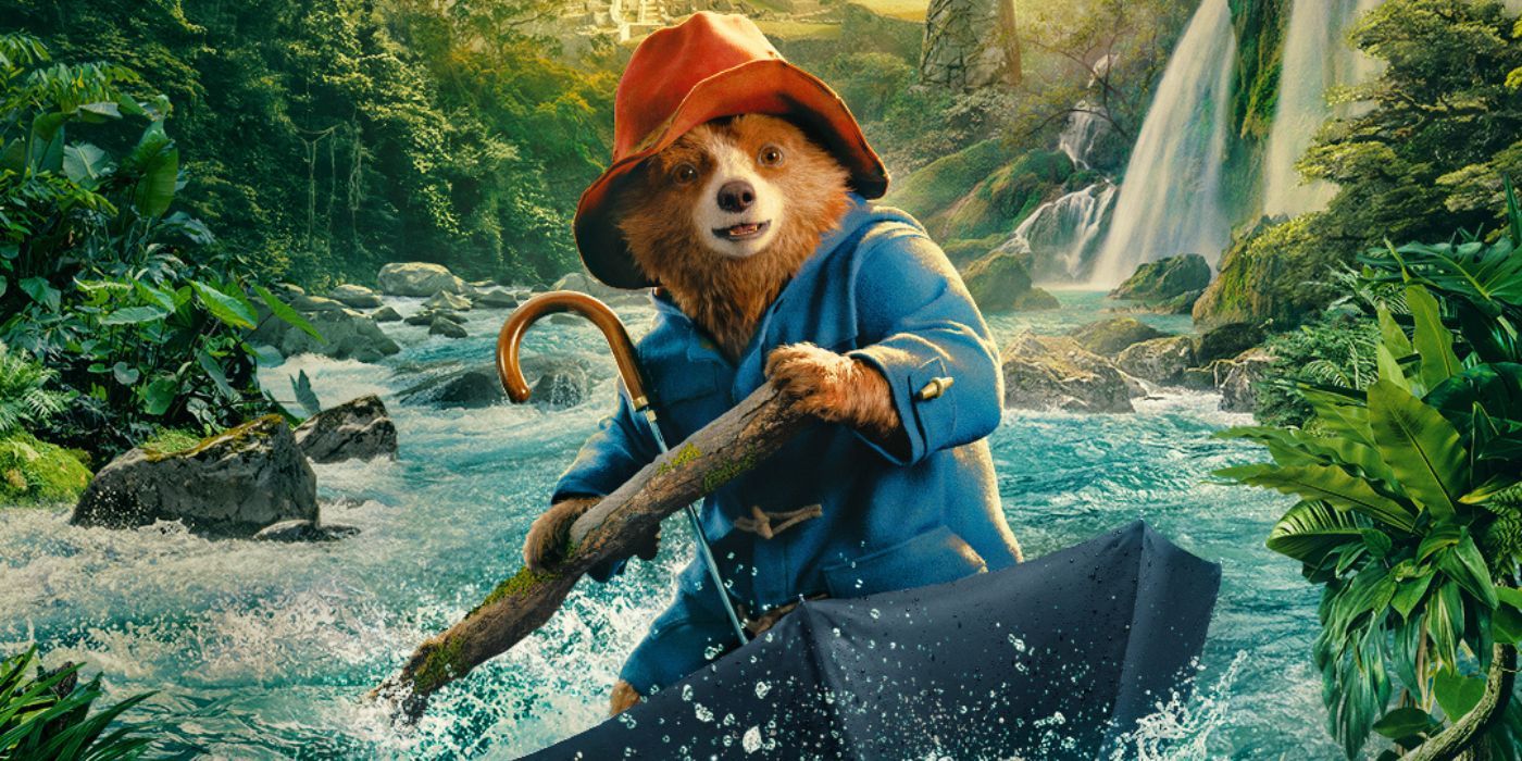 Paddington riding on an umbrella on the poster for his new movie.