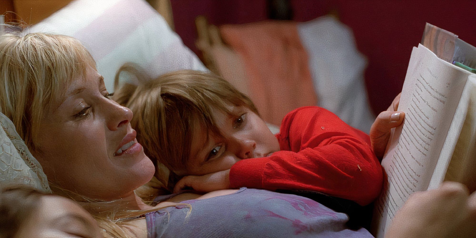 Patricia Arquette as Olivia lying next to a child in bed in Boyhood.