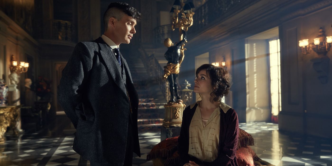 Tommy Shelby (Cillian Murphy) stands over May Carleton (Charlotte Riley) in an expansive and lavish hallway in 'Peaky Blinders' Season 2, Episode 5 (2014).