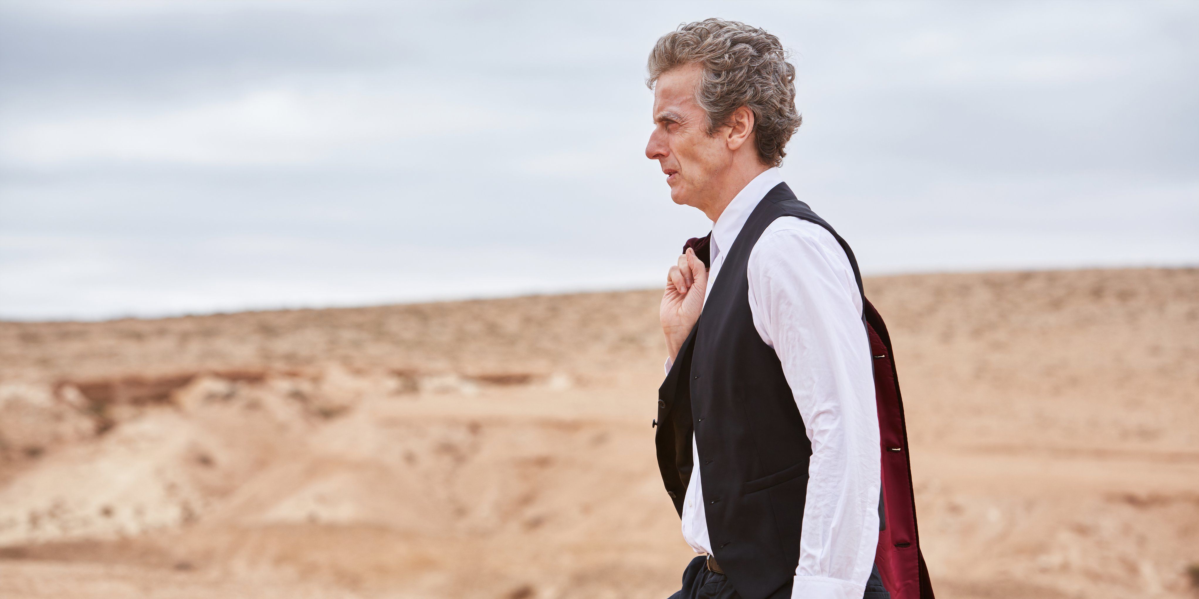 Peter Capaldi as The Twelfth Doctor strolling through Gallifrey with his jacket over his shoulder in Doctor Who, "Hell Bent".
