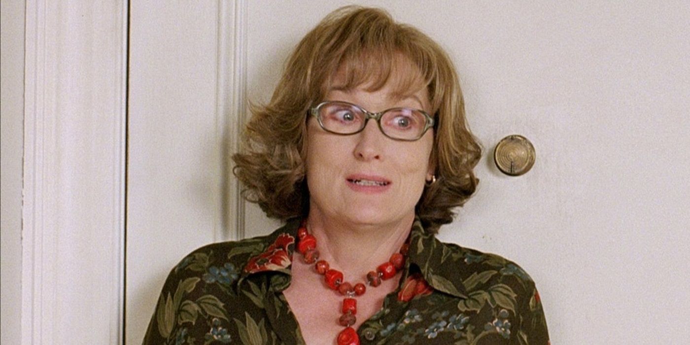 Meryl Streep as Lisa leaning on the door in her office and looking anxious in Prime (2005).