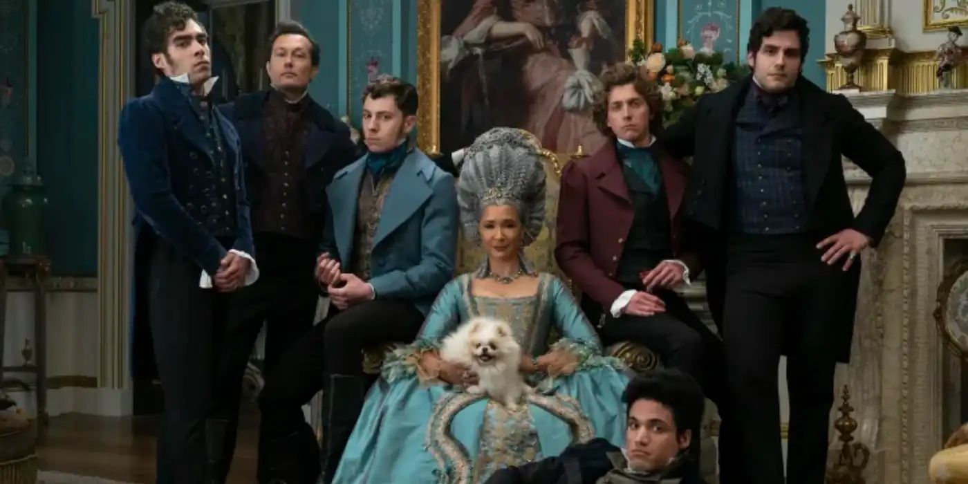 Queen Charlotte is sitting on a grand chair with a small dog on her lap whilst her five sons stand behind her. One son is lying on the ground in front of her.