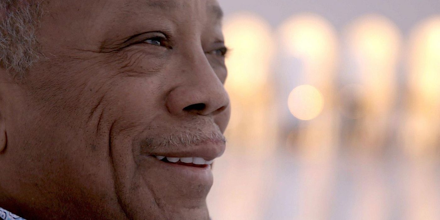 Quincy Jones smiling in the Netflix documentary Quincy