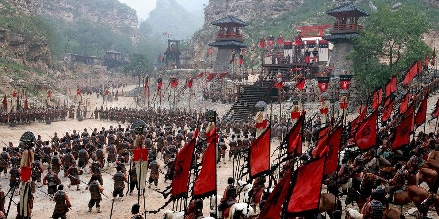 Armies bearing red flags surround a mountain fortress in 'Red Cliff'