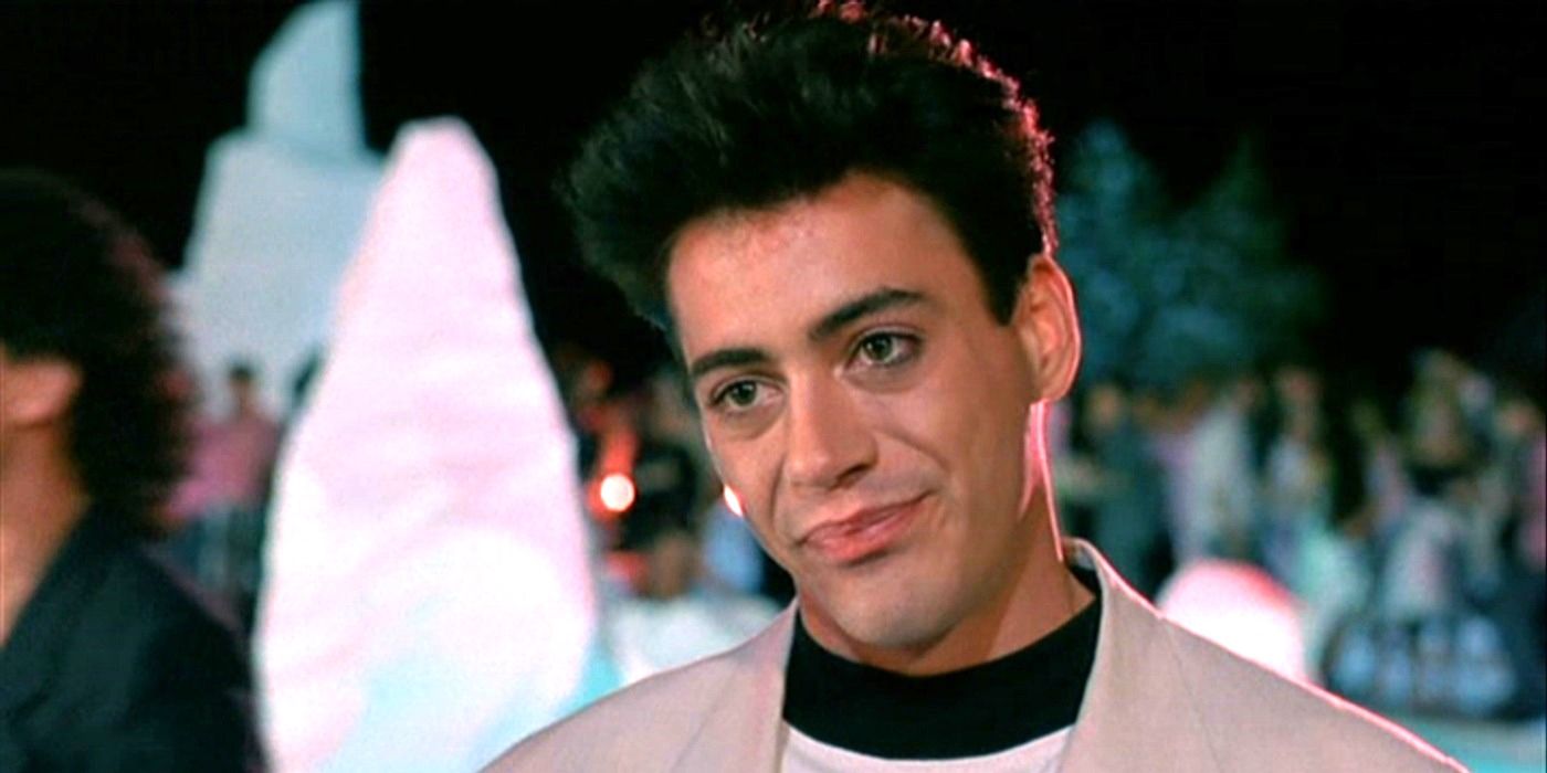 Robert Downey Jr. as Julian Wells looking at a person offscreen with a slight smirk in Less than Zero