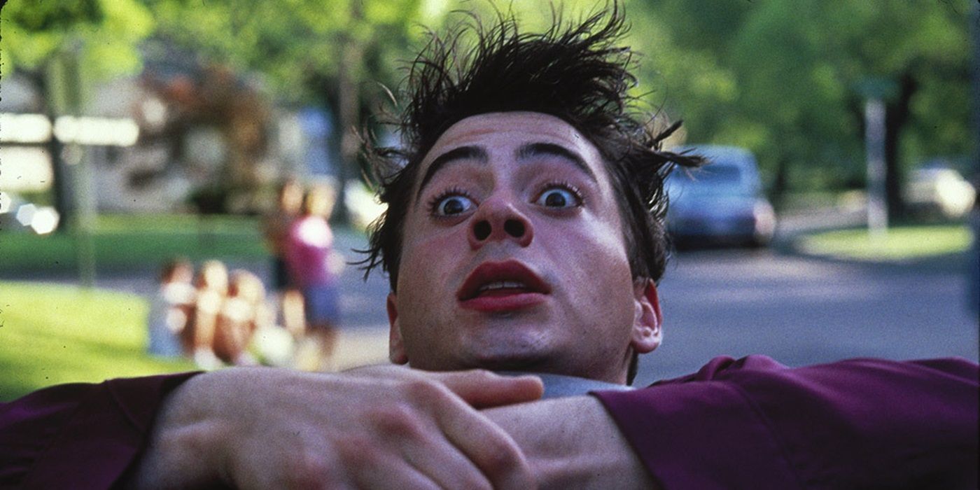 Robert Downey Jr as Leo Wiggins, tilting his head back while looking surprised, in Johnny Be Good