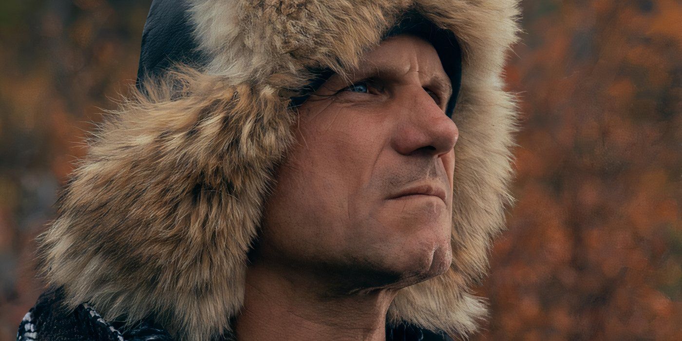 A man with a fur hat stares off into the distance