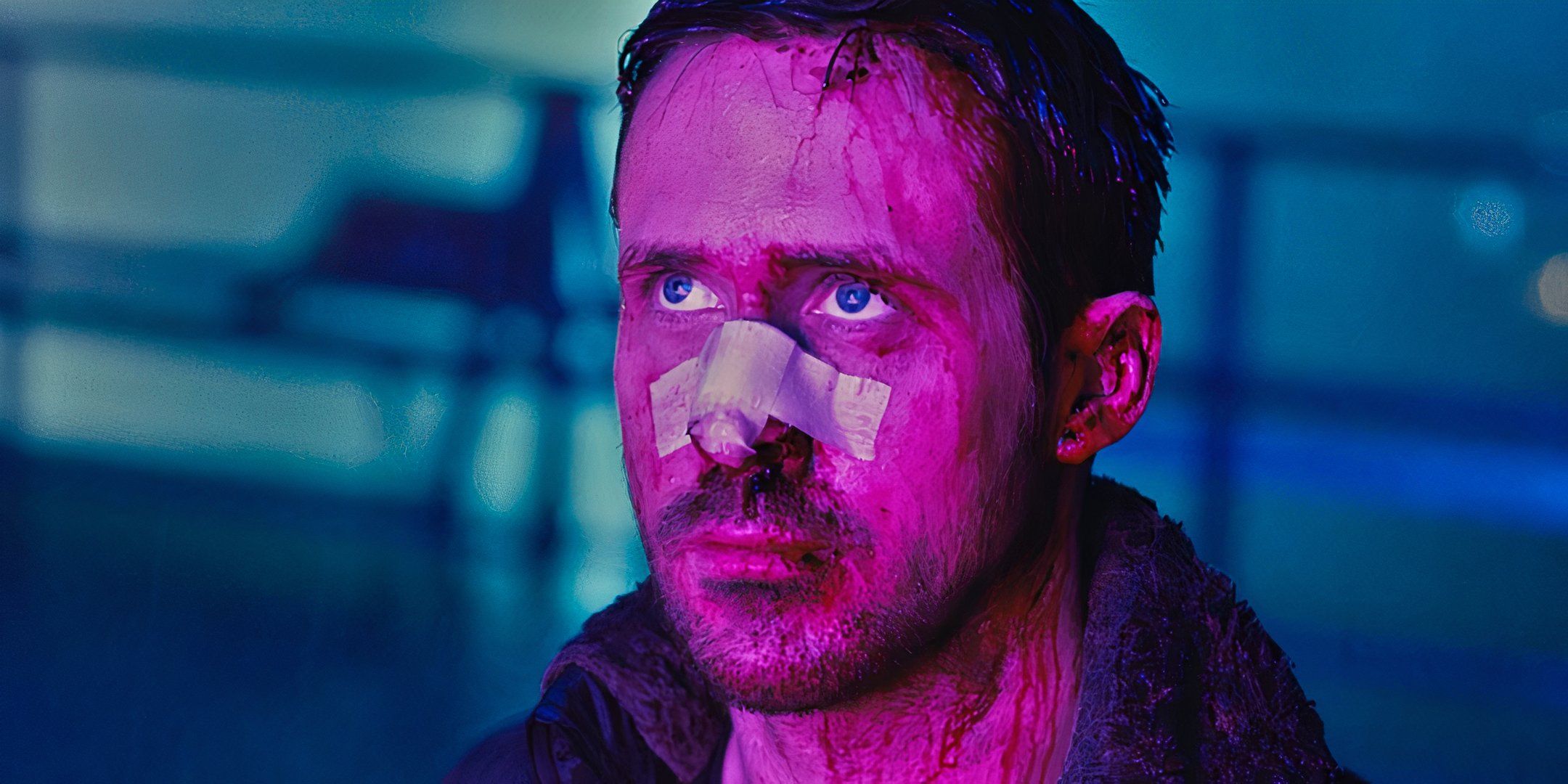 Officer K under the rain looking up at something in Blade Runner 2049