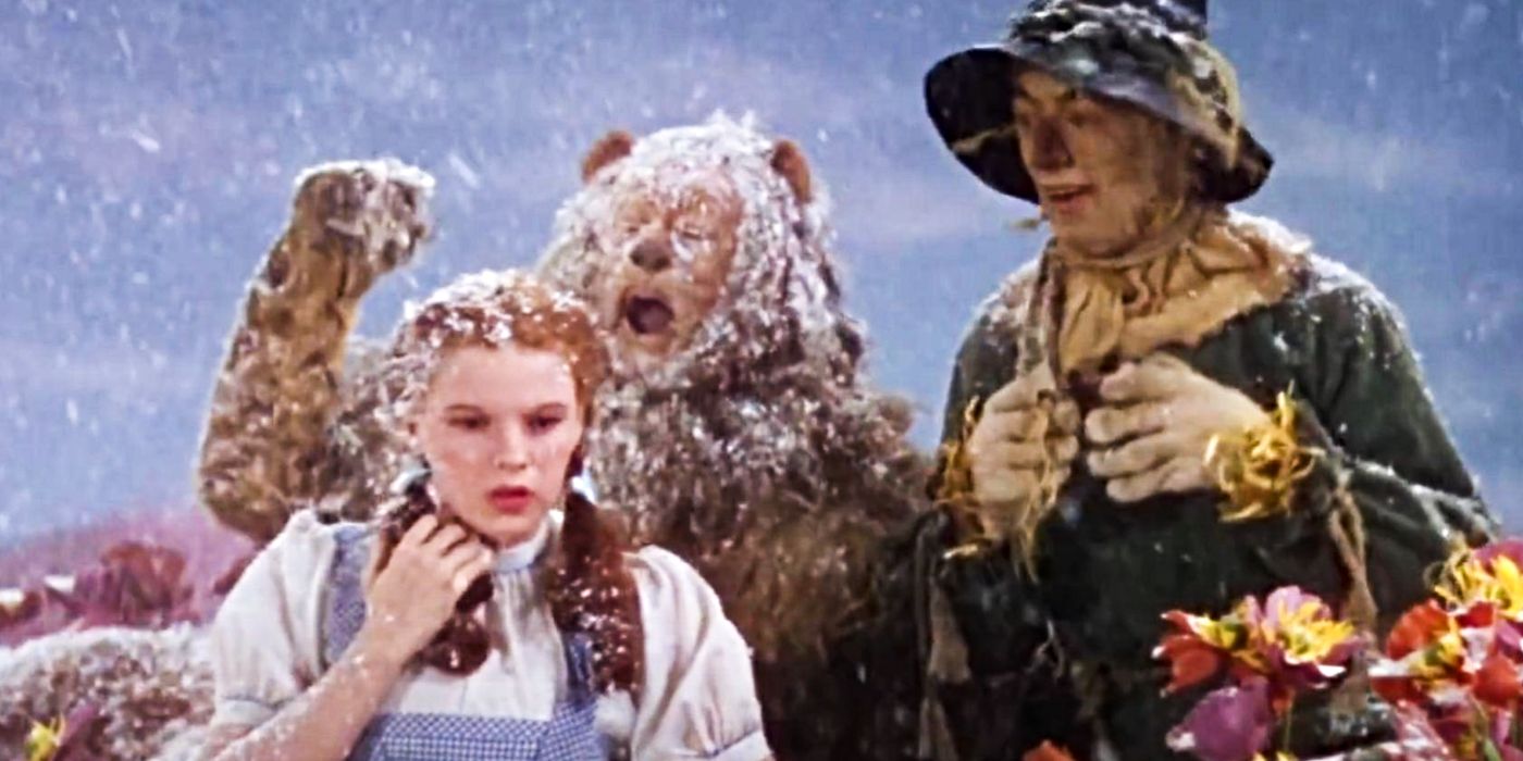 Dorothy (Judy Garland), the Scarecrow (Ray Bolger), and the Cowardly Lion (Bert Lahr) waking up in a field of flowers covered in snow in The Wizard of Oz