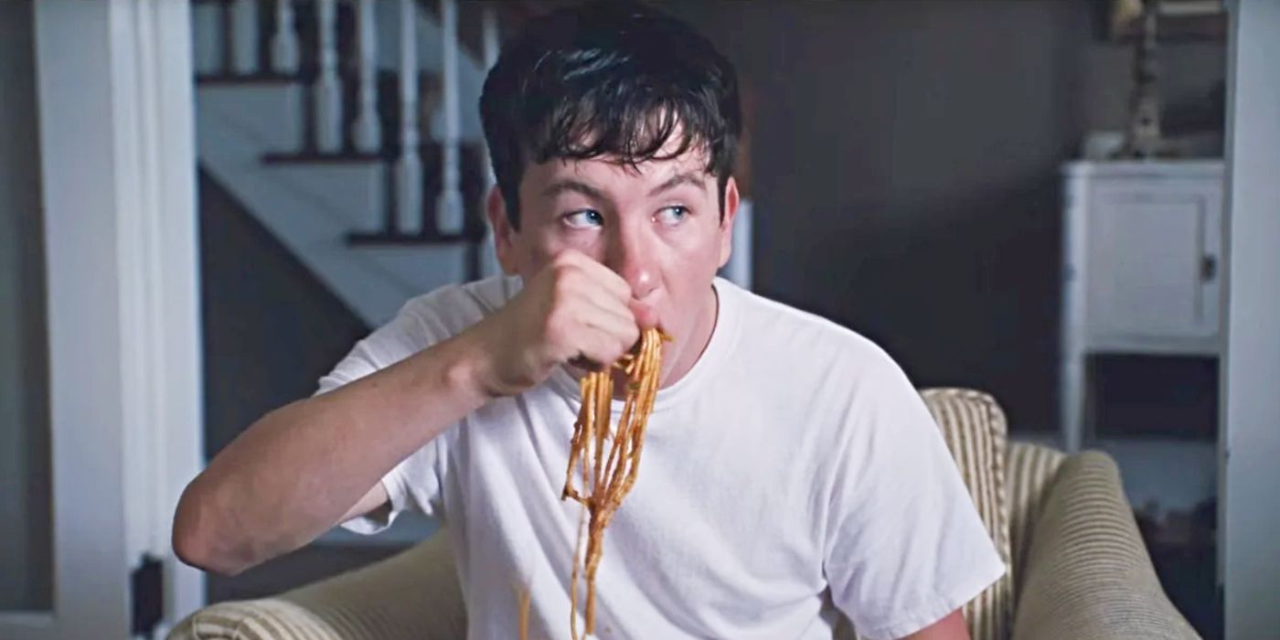 Barry Keoghan as Martin Lang, wearing a white t-shirt and eating spaghetti with his hand