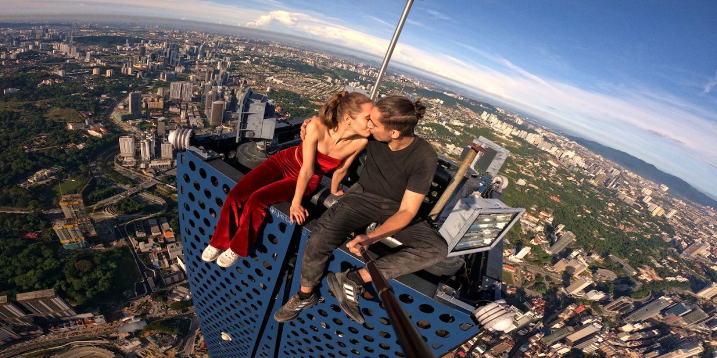 Angela Nikolau and Ivan Beerkus  sitting atop a skyscraper in Skywalkers: A Love Story