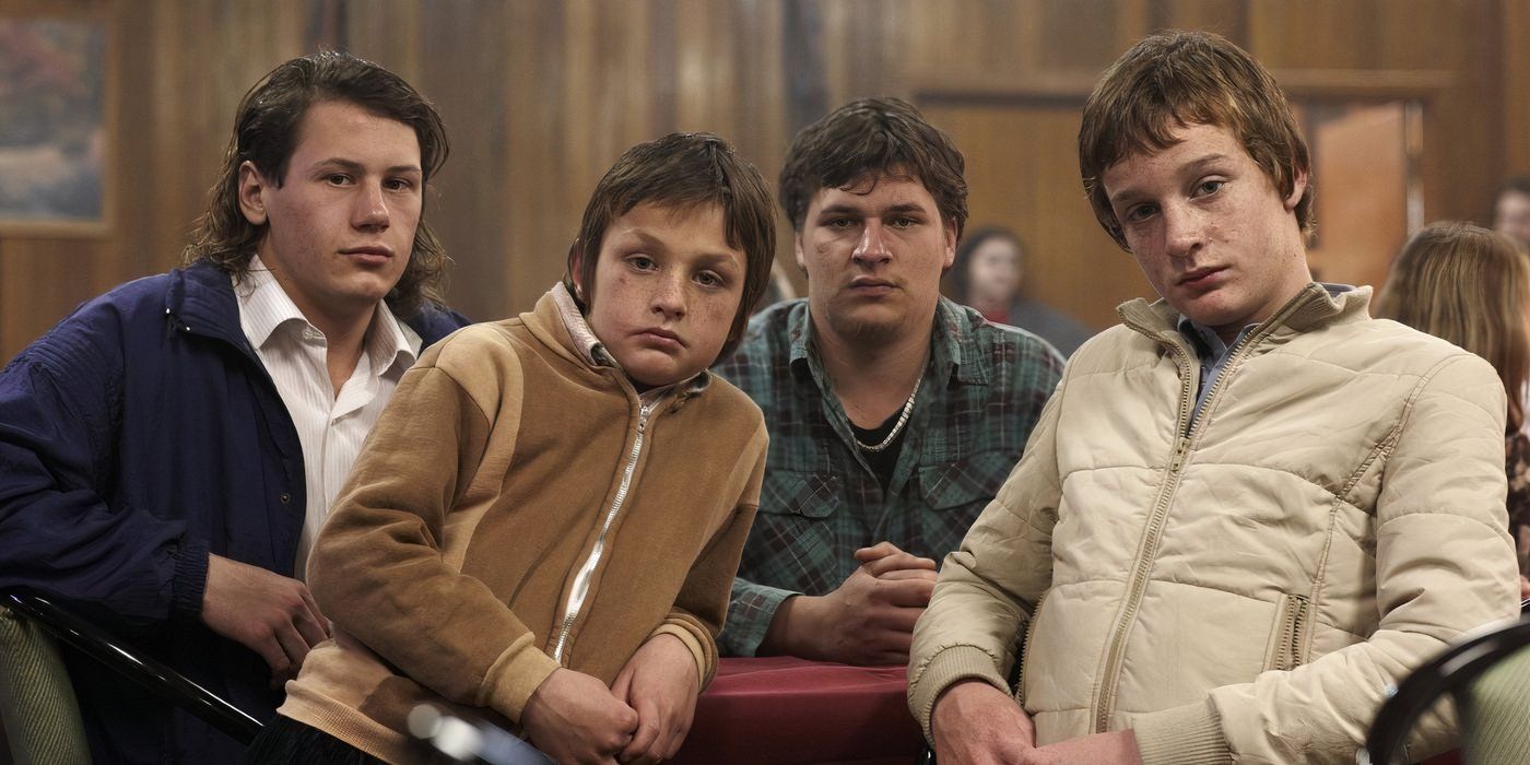 From left to right: Jamie (Lucas Pittaway), Mark (David Walker), John (David Henshall) and Robert (Aaron Viergever) sitting in a convertible car. 