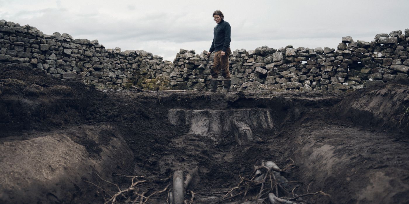 Matt Smith looks down at a pit of roots in Starve Acre