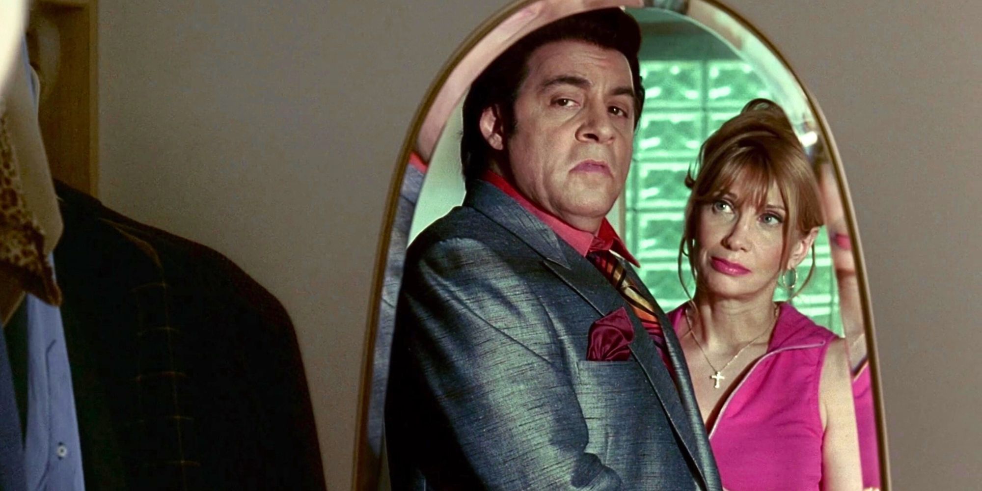 Steven Van Zandt standing in front of a mirror with Maureen Van Zandt standing behind him in The Sopranos