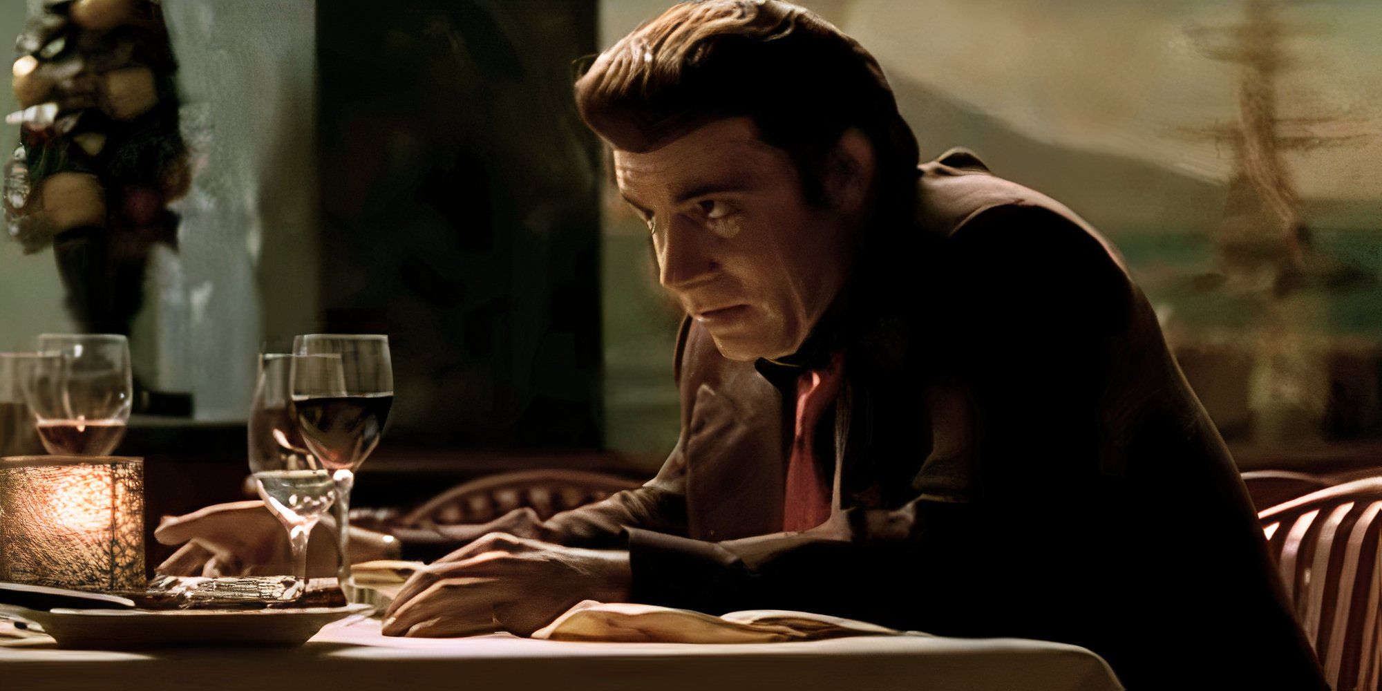 Steven Van Zandt as Silvio Dante sitting at a table in The Sopranos