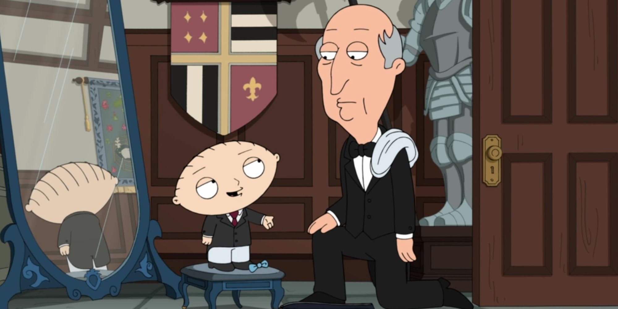 Stewie Griffin standing on a stool in front of a mirror while speaking to a man kneeling down next to him in Family Guy