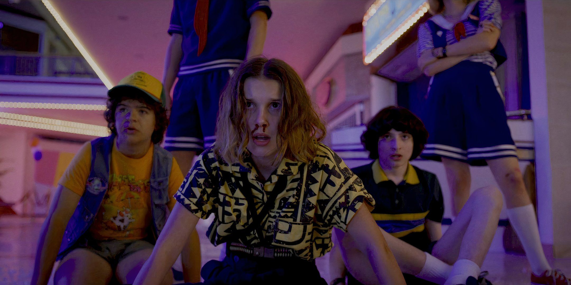 Eleven, with a bloody nose, and Dustin and Mike behind her on the floor at the mall, looking scared