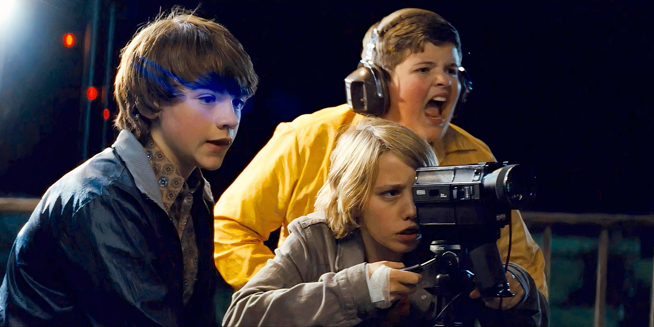 Joe (Joel Courtney), Alice (Elle Fanning), and Charles (Riley Griffiths) shoot a movie in 'Super 8' (2011)