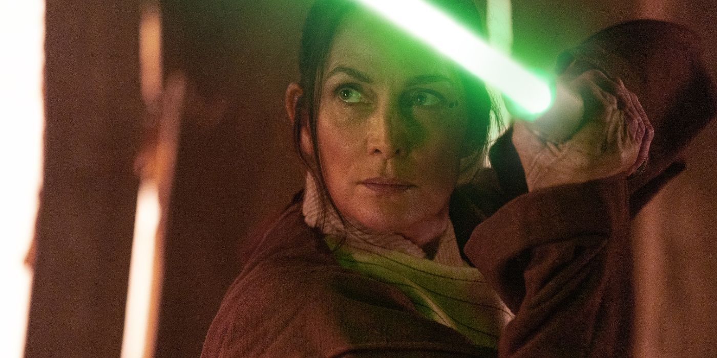 Carrie-Anne Moss as Indara brandishing a lightsaber in The Acolyte Episode 1
