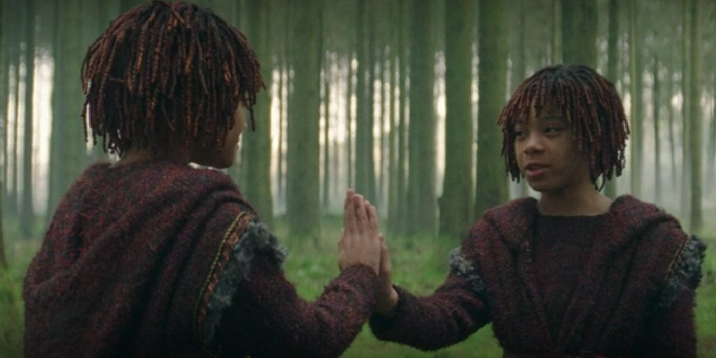 Young Osha (Lauren Brady) and Mae (Leah Brady) put their hands together in the forest in The Acolyte