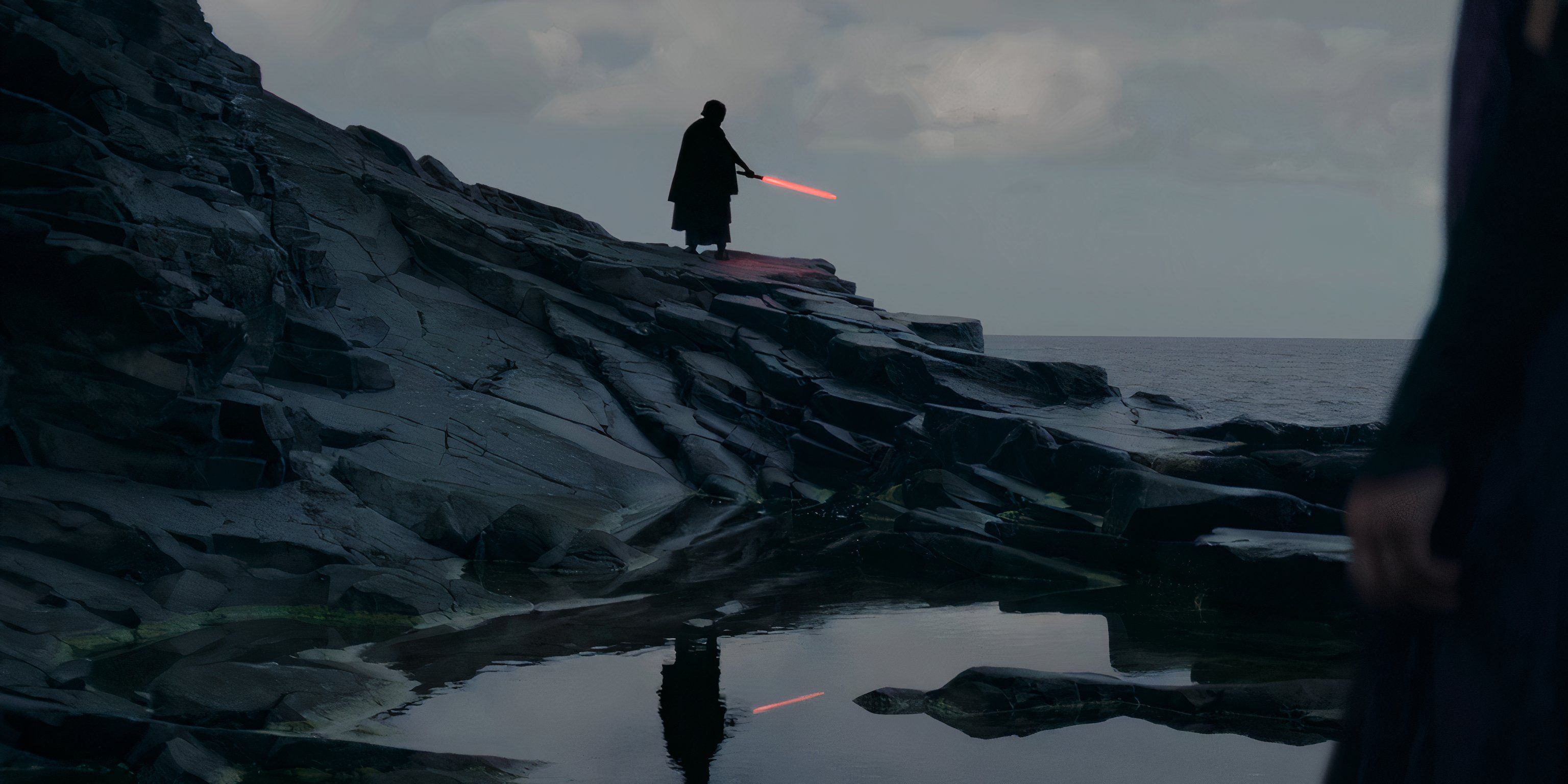 The Master stands in the distance holding a red lightsaber